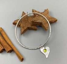 Load image into Gallery viewer, Textured bangle with a peridot gemstone heart charm in Sterling silver
