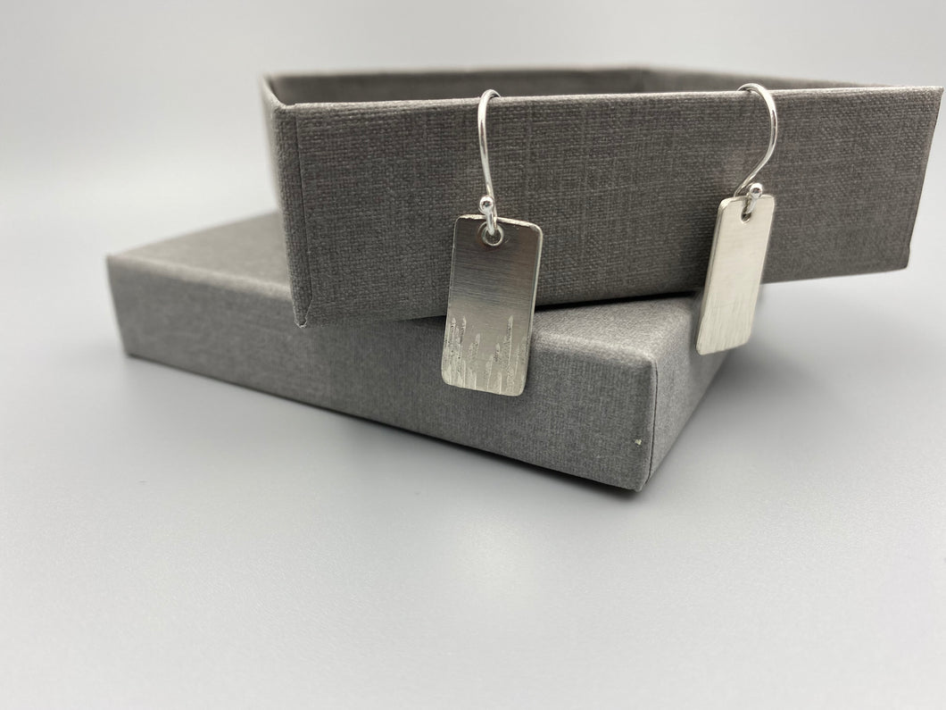 Sterling silver part line textured earrings