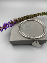 Load image into Gallery viewer, Sterling silver dimple and linear texture double bangle with a heart charm
